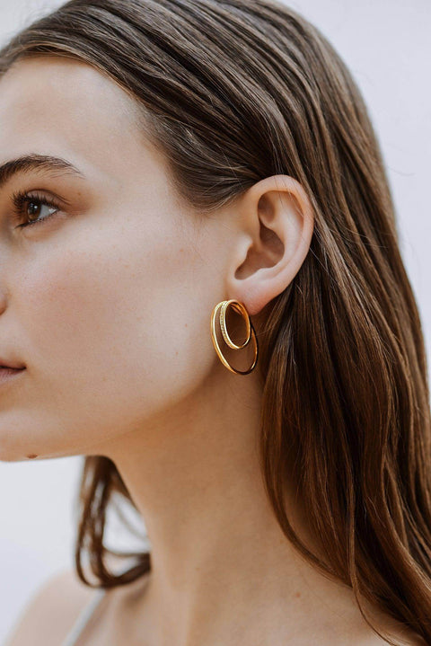 A model wearing Cleopatra double hoop earrings - 9k recycled gold lab-grown diamond earrings from The Future Rocks