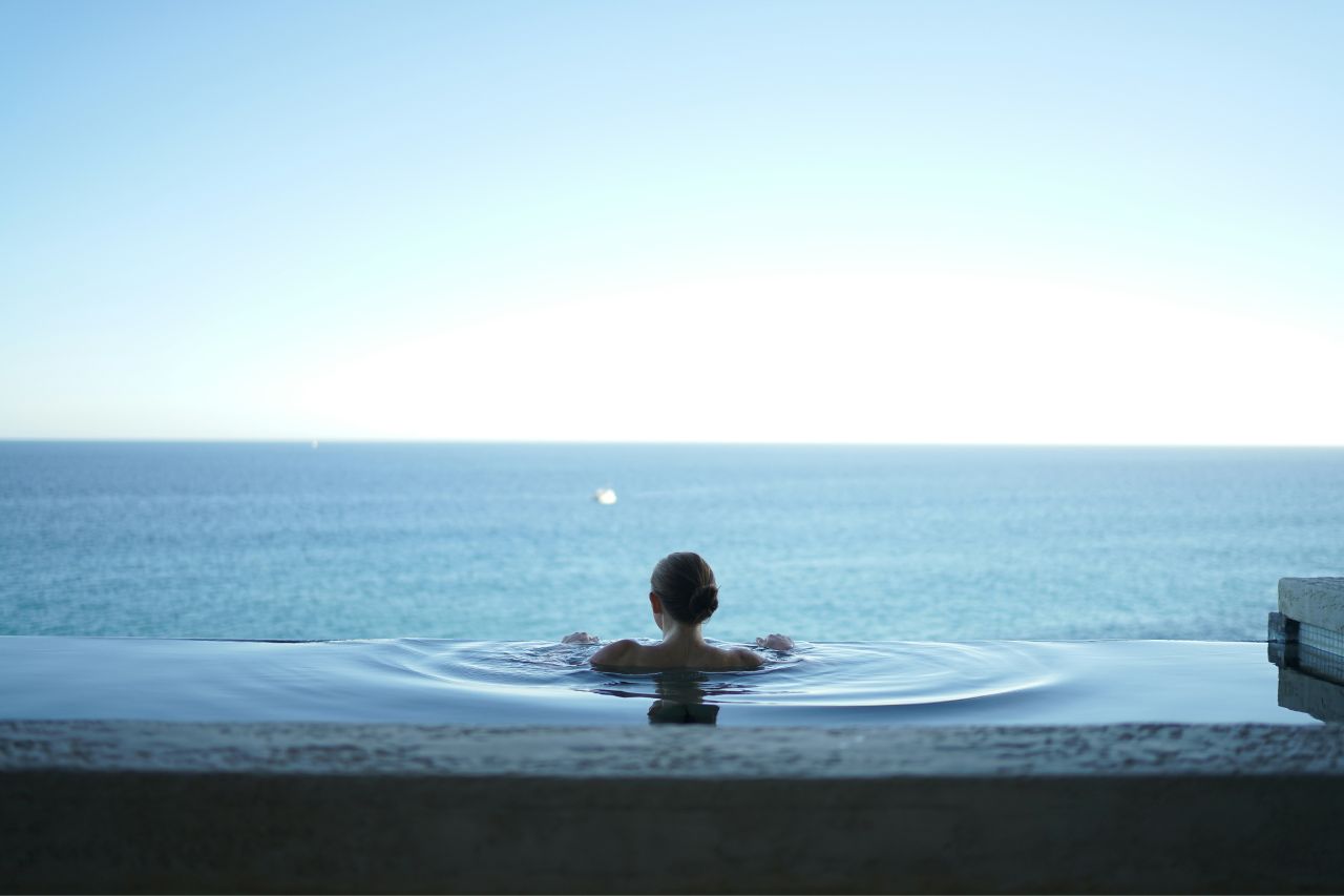 woman at a pool looking out 