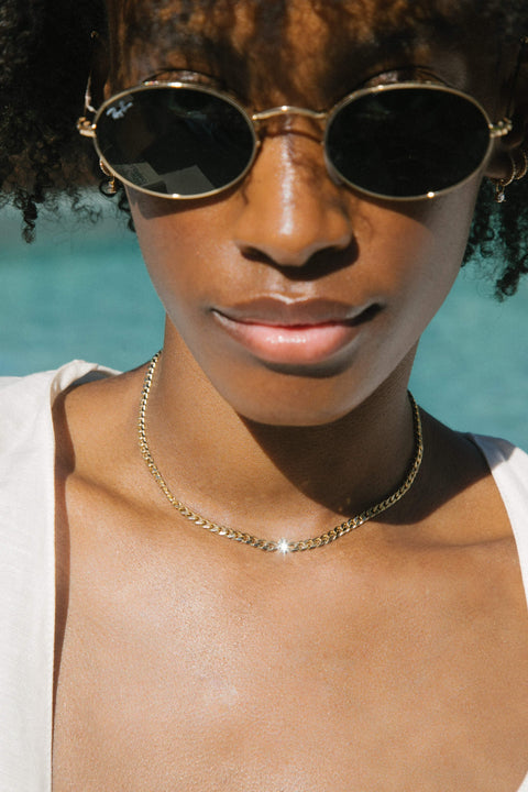 A model wearing Chuva necklace, 14 recycled gold lab-grown diamond chain necklace from The Future Rocks