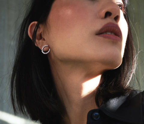 A model wearing Aurora hoop earrings - 18k recycled gold lab-grown-diamond hoop earrings from The Future Rocks 