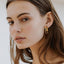 A model wearing Cleopatra double hoop earrings - 9k recycled gold lab-grown diamond earrings - The Future Rocks