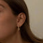 A model wearing Amaris earrings - 18k recycled gold lab-grown-diamond hoop earrings from The Future Rocks